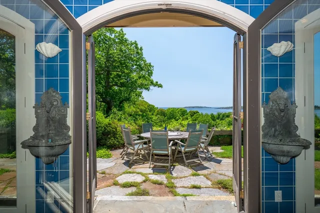 a view of a patio with table and chairs potted plants