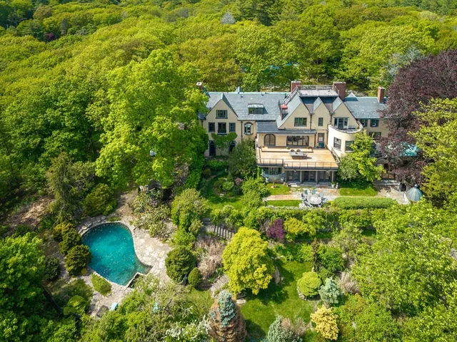 an aerial view of a house with a yard