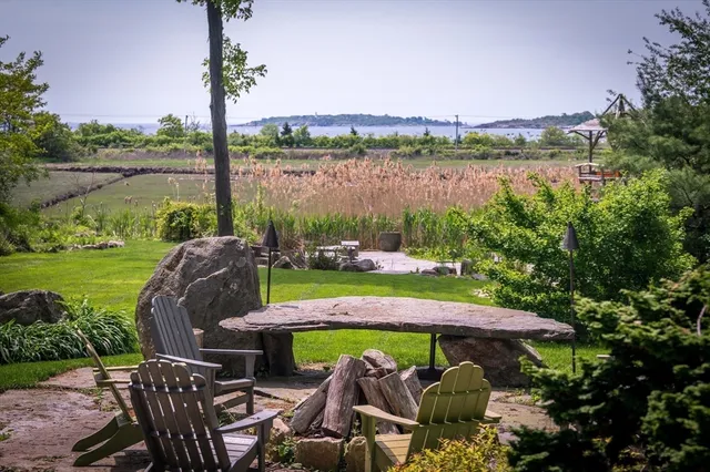 a view of a swimming pool and outdoor seating