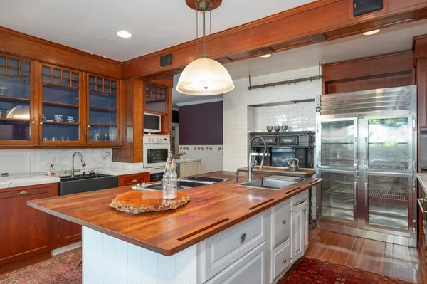 a kitchen with a sink and a wooden floor