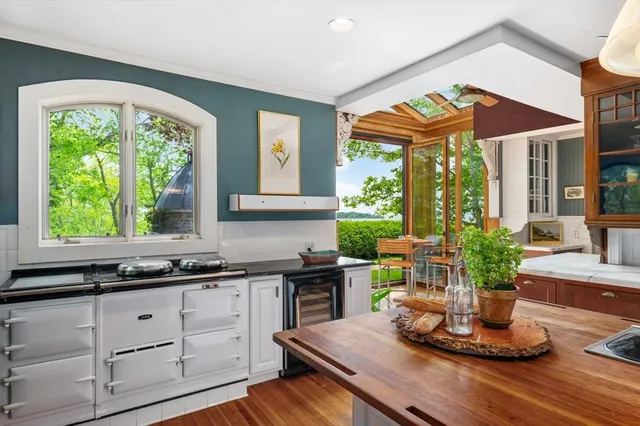 a kitchen with a large window and cabinets