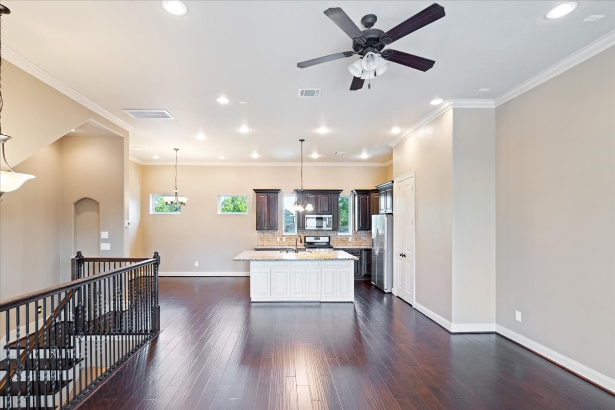 1516 Amundsen Street Houston, TX 77009 - Photo 18 of 32 a living room with stainless steel appliances kitchen island furniture and wooden floor