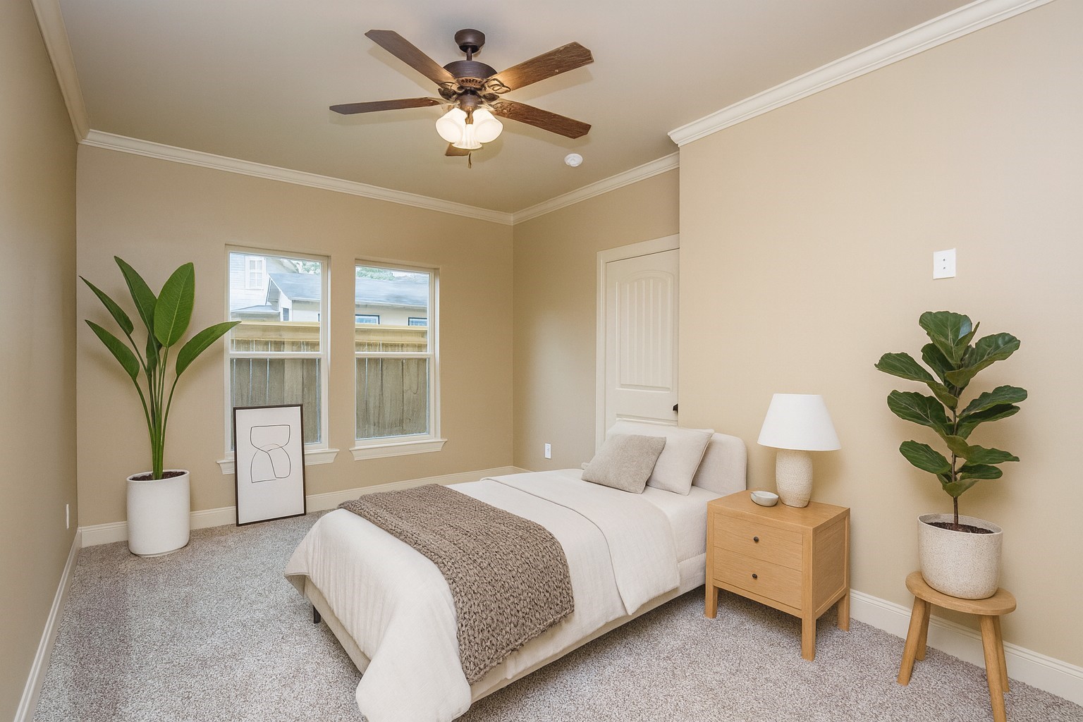 1516 Amundsen Street Houston, TX 77009 - Photo 22 of 32 a bedroom with a large bed and a chandelier