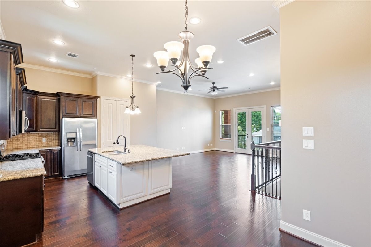 1516 Amundsen Street Houston, TX 77009 - Photo 10 of 32 a view of a kitchen with furniture and wooden floor
