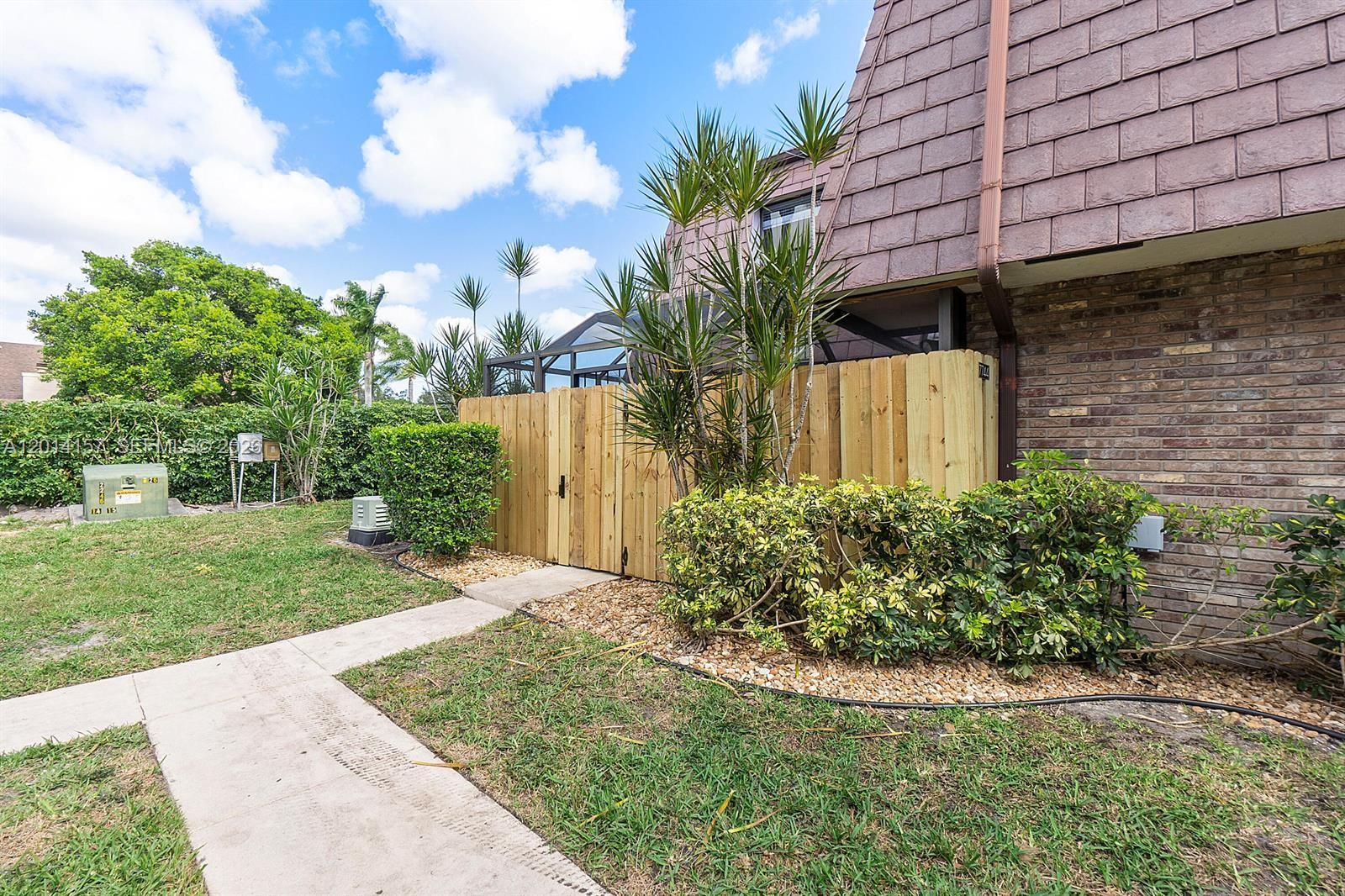7744 Courtyard Run West Boca Raton, FL 33433 - Photo 20 of 25 a view of a backyard with potted plants