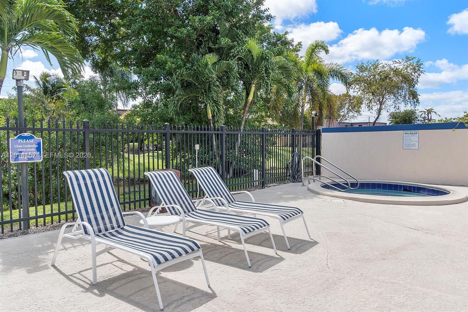 7744 Courtyard Run West Boca Raton, FL 33433 - Photo 24 of 25 a view of a patio with two chairs and a table