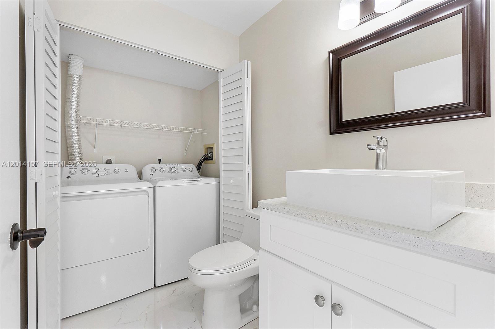 7744 Courtyard Run West Boca Raton, FL 33433 - Photo 6 of 25 a bathroom with a sink toilet vanity and mirror
