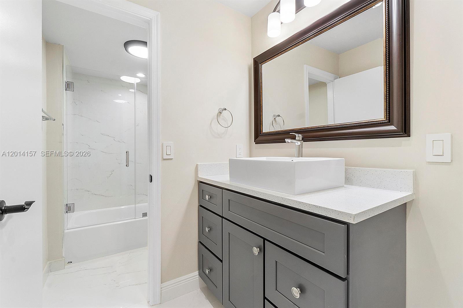 7744 Courtyard Run West Boca Raton, FL 33433 - Photo 9 of 25 a bathroom with a sink vanity tub and a mirror