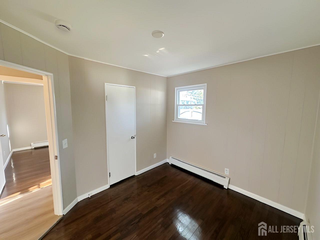 125 Raritan Boulevard Old Bridge, NJ 07735 - Photo 14 of 29 a view of an empty room with wooden floor and a window
