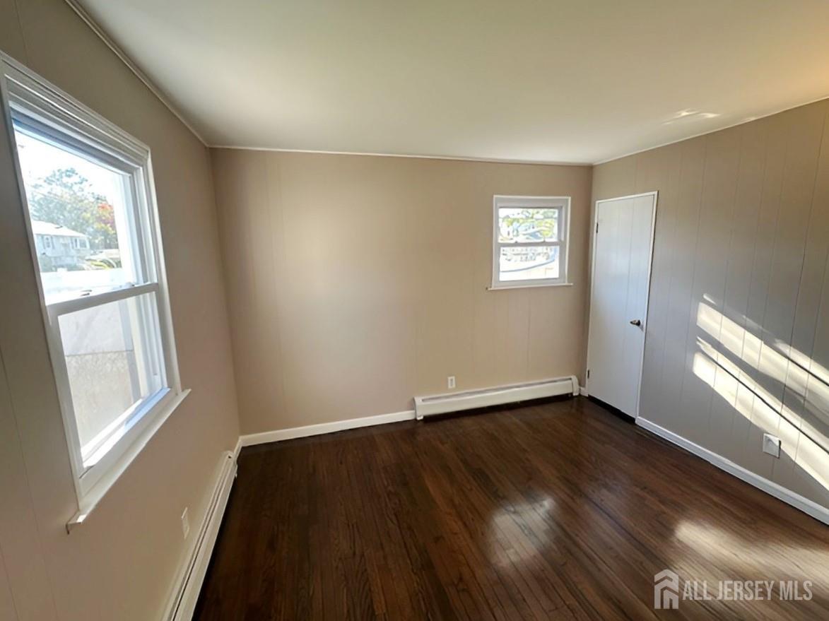 125 Raritan Boulevard Old Bridge, NJ 07735 - Photo 16 of 29 a view of an empty room with wooden floor and a window