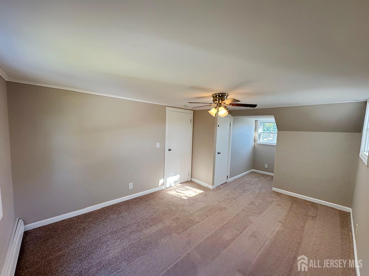 125 Raritan Boulevard Old Bridge, NJ 07735 - Photo 17 of 29 an empty room with closet and a chandelier fan