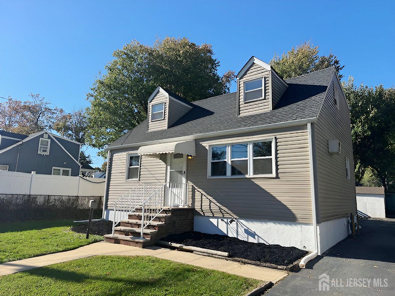 125 Raritan Boulevard Old Bridge, NJ 07735 - Photo 28 of 29 a front view of a house with a yard