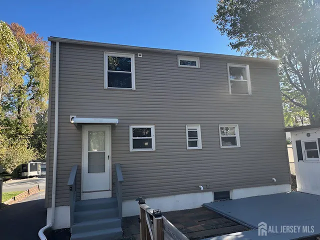 a view of a house with wooden fence