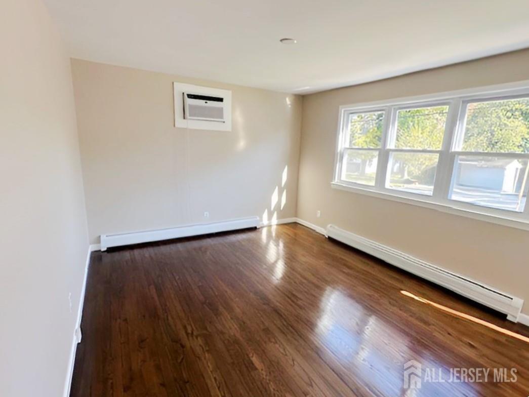 125 Raritan Boulevard Old Bridge, NJ 07735 - Photo 5 of 29 wooden floor in an empty room with a window