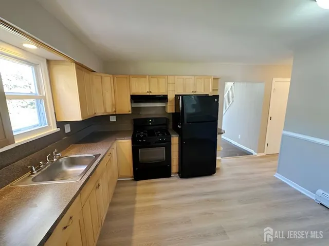a kitchen with a refrigerator and a sink