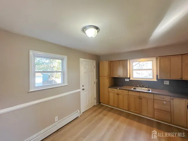 a kitchen with granite countertop a sink and cabinets