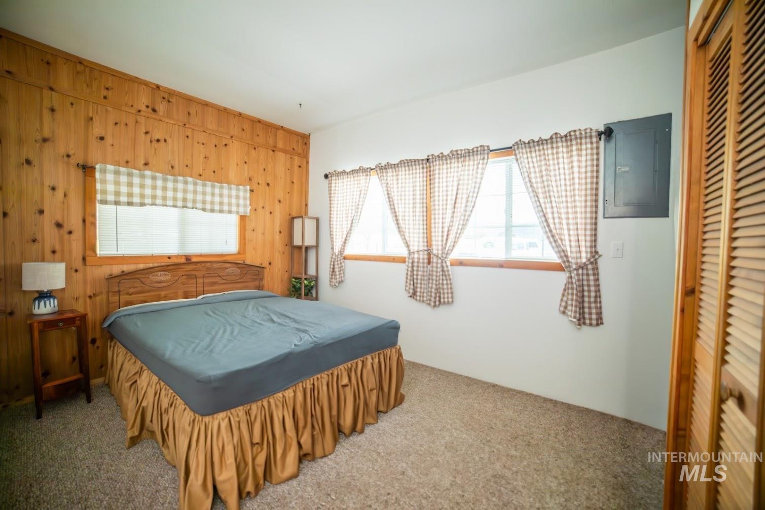 69431 Antles Road, Unit 1 Cove, OR 97824 - Photo 14 of 23 Bedroom with wood walls, carpet flooring, electric panel, and a closet
