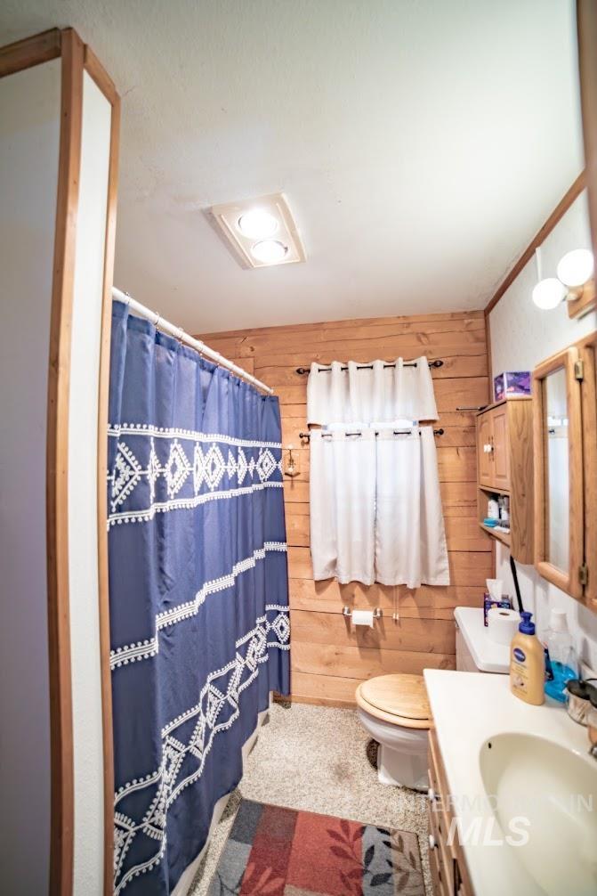 69431 Antles Road, Unit 1 Cove, OR 97824 - Photo 8 of 23 Full bathroom with wood walls, vanity, and a shower with curtain