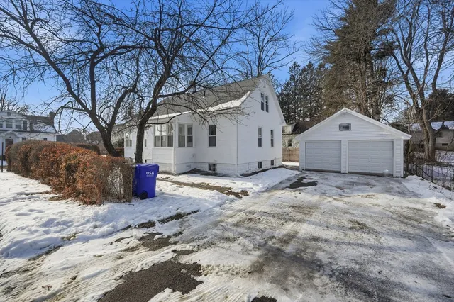 a view of a house with a yard covered in snow