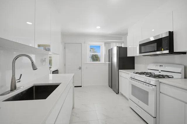 a kitchen with a sink a stove and refrigerator