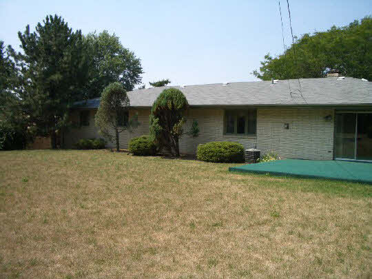 4203 Singleton Road Rockford, IL 61114 - Photo 2 of 6 a front view of a house with a yard and garage