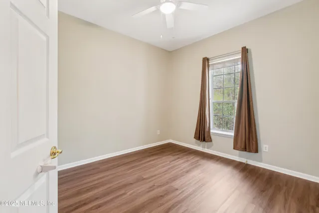 an empty room with wooden floor