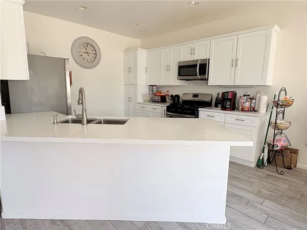 a kitchen with a sink and a stove top oven