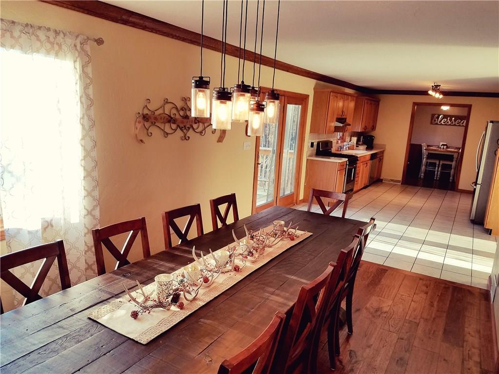 224 Stark Road Sarver, PA 16055 - Photo 5 of 25 Walk straight out to a multi-tiered deck from the double doors in the kitchen, overlooking the pool, level yard space, and woods.