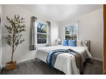 a bedroom with a bed and a potted plant