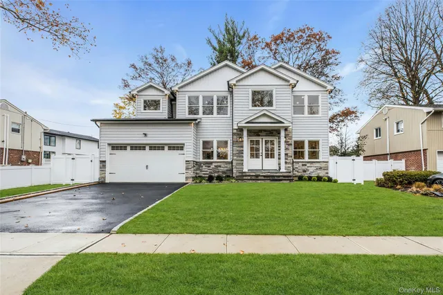 a front view of a house with a garden