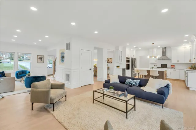 a living room with furniture and kitchen view