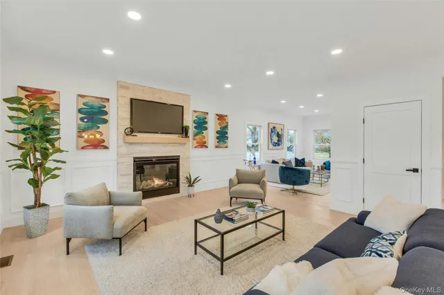 a living room with furniture potted plant and a fireplace