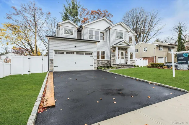 a view of a white house with a yard