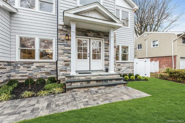 a view of a house with a yard and sitting area