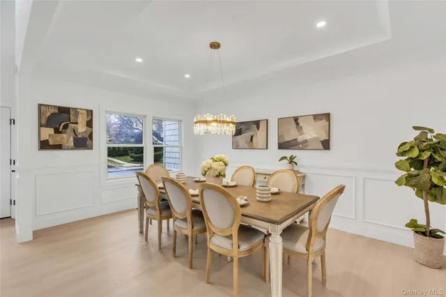 a view of a dining room with furniture and a potted plant