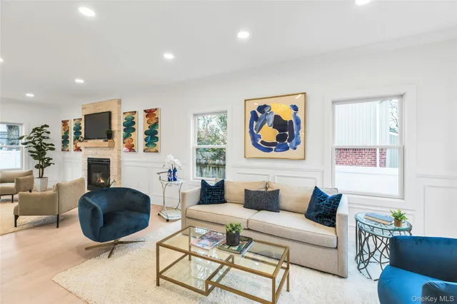 a living room with furniture a rug and a fireplace