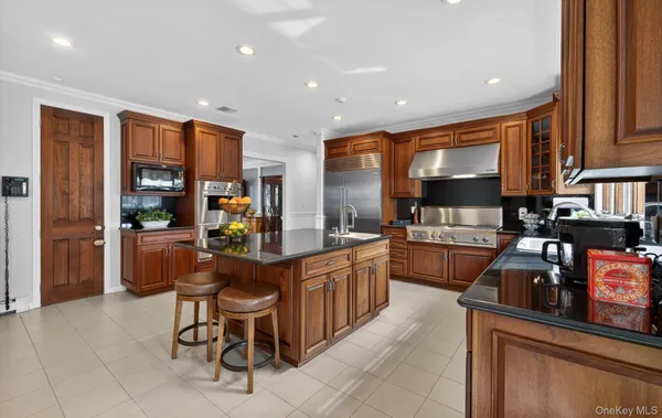a kitchen with stainless steel appliances kitchen island granite countertop a sink and cabinets