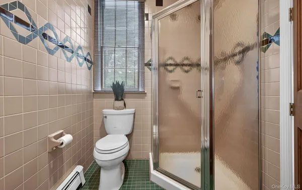 a bathroom with a toilet and a shower