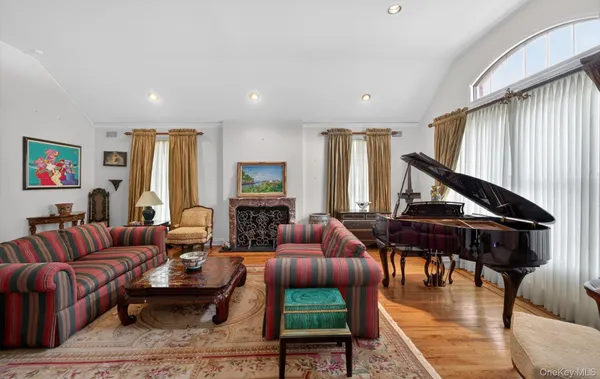 a living room with furniture fireplace and a window