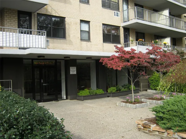 a front view of a building with a garden