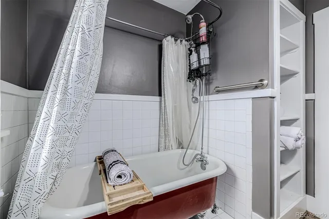 a bathroom with a bathtub and shower