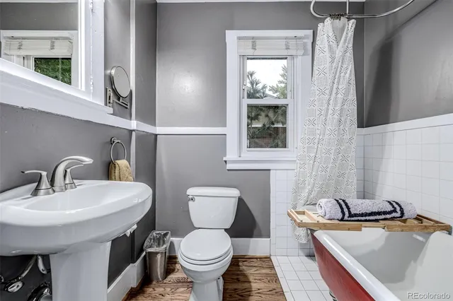 a bathroom with a sink toilet and mirror