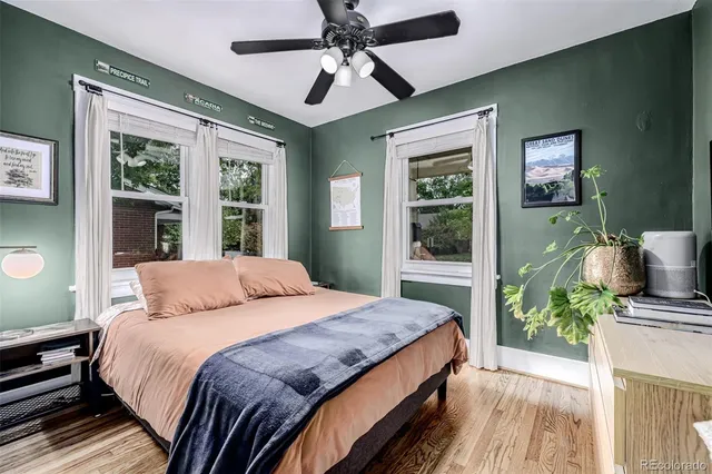 a bedroom with a large bed chandelier and a window