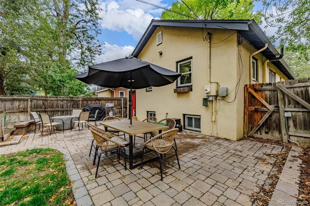 a patio with table and chairs