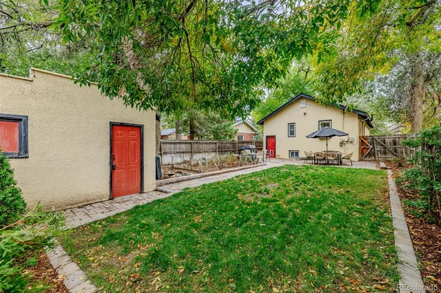 a view of backyard of house with green space
