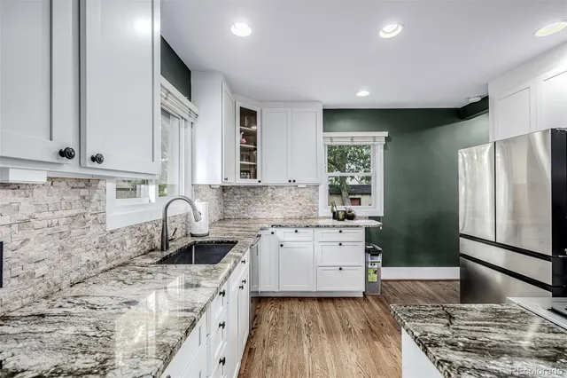 a kitchen with a sink stove and refrigerator