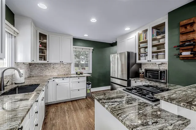 a kitchen with a stove a sink and a refrigerator