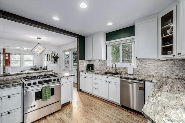 a kitchen with stainless steel appliances a stove sink and cabinets