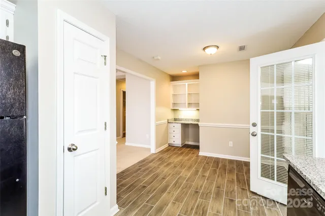 a view of a kitchen with wooden floor and a sink