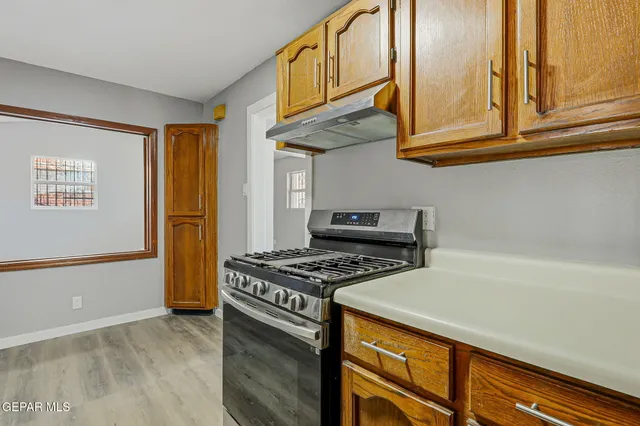 a kitchen with stainless steel appliances granite countertop a stove and a microwave